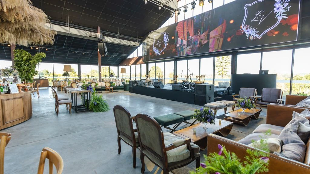 An industrial wedding reception with steel beams and candlelight.