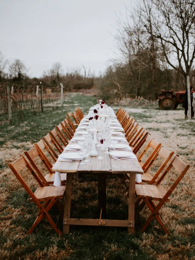 A long farm-to-table wedding table in a vegetable garden.