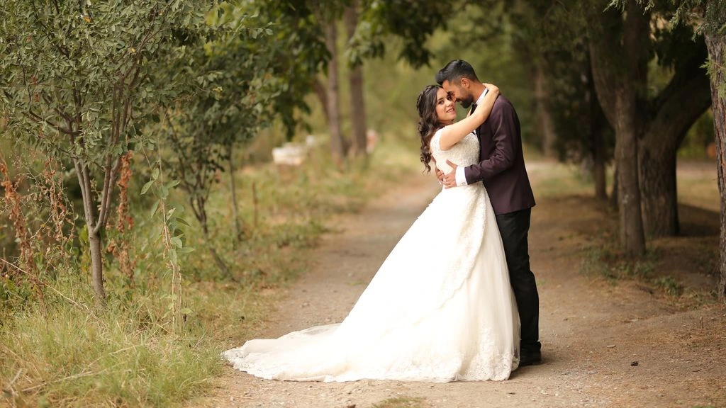 Two brides sharing a candid dance-floor moment at an outdoor reception.
